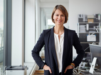 Confident businesswoman smiling in a modern office setting