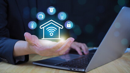 Smart Home Concept Businessman using computer to control technology system Modern home Control and protect the system by giving commands online.
