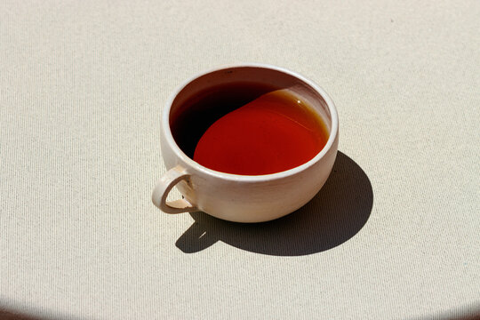 Elegant cup of red tea on a table with a tablecloth