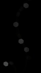 A series of soft glowing hexagonal lights are arranged vertically against a dark backdrop creating a calming and intriguing visual effect that draws attention