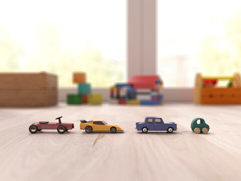 Wooden toy cars arranged in a row on a playroom floor indoors