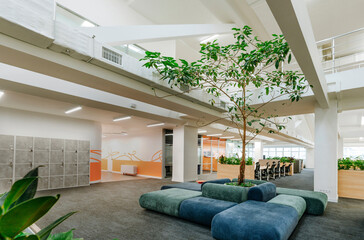 Modern coworking office interior with plants and seating area