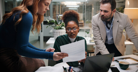 Business people, document and meeting in office for discussion, project feedback and advice at night. Journalist team, paper and tech in agency for article review, collaboration and late information