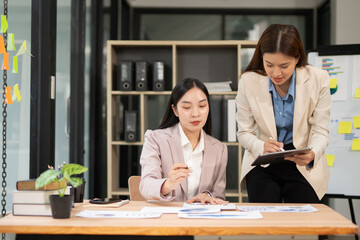 Two businesswoman hands or accountants working together on financial investment on calculator, calculating, analyzing business growth and marketing on graph.