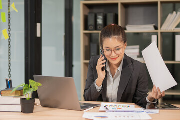Businesswoman calling customer consultant employee in office in the morning, finance manager talking on phone and solving problem with smartphone in corporate communication.