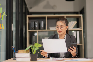 Happy businesswoman wearing glasses at work using modern laptop