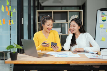 Two businesswoman hands or accountants working together on financial investment on calculator, calculating, analyzing business growth and marketing on graph.