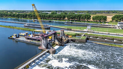 Aerial drone view of dum weir engineering construction on river Meuse, the Netherlands