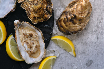 open oysters and lemons on the table