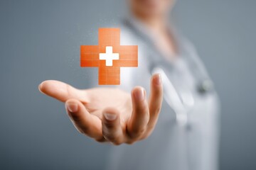 Woman's Hand Presenting a Glowing Orange Digital Cross Medical Symbol