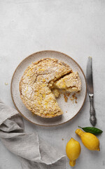 Freshly Baked Lemon Pie, Delicious Citrus Tart on the plate with cut piece, top view, copy space