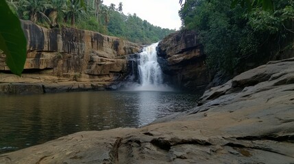 Obraz premium Majestic waterfall cascading into tranquil pool in lush jungle a serene nature photography adventure