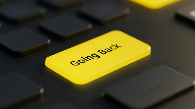 Close-up of yellow "Going Back" button on a black keyboard  