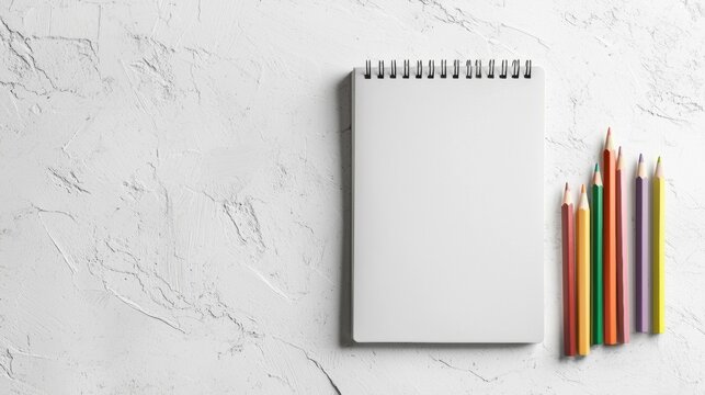 White notebook with a blank white cover on a white textured background. - Powered by Adobe