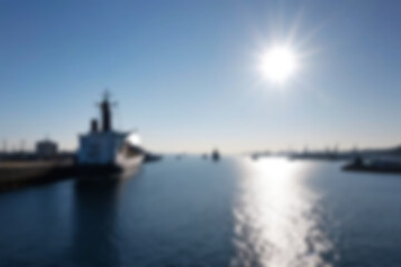 Fototapeta premium blurry harbor, bright ship harbor, exposed to morning sunlight, large ships are seen docked at the harbor pier, wallpaper, blurry background.