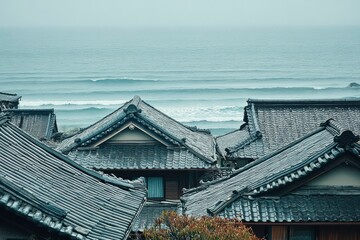 Naklejka premium traditional hut rooftops and seafoam waves a union of land and sea in dusty blue