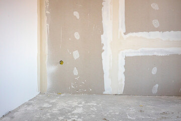 Assembled plasterboards on wall of an unfinished edifice on the building site