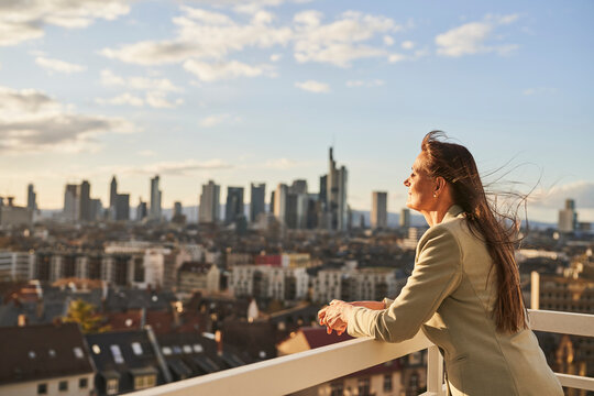 Businesswoman looking at cityscape view while standing on rooftop