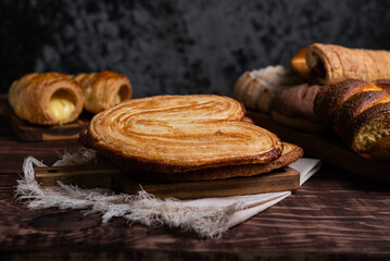 Variety of freshly baked pastries, including palmiers, cream puffs, and other delightful treats.