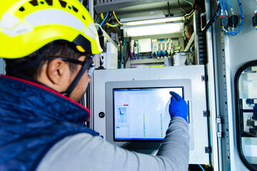 Engineer operating medium voltage cell in wind turbine tower