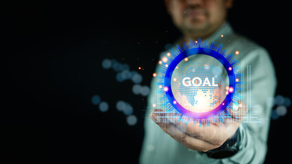 Hand holding a goals target text, representing focus on business goals and objectives for the...
