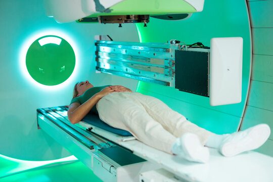 Patient undergoing proton therapy treatment in a modern medical facility