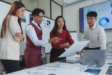 Business people analyzing charts and reports in a meeting room