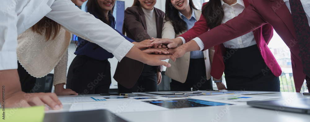 Poster business team stacking hands together showing teamwork and unity