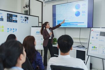 Businesswoman presenting data analysis in office meeting