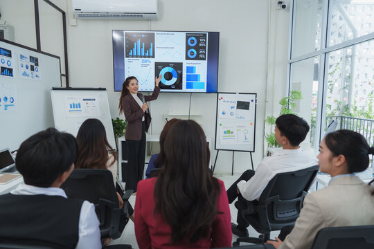 Businesswoman presenting data analysis in modern office