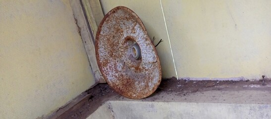 Rusty Metal Disc with Central Light Fixture