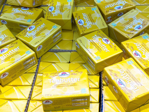 Teebutter blocks in bright yellow packaging with floral design