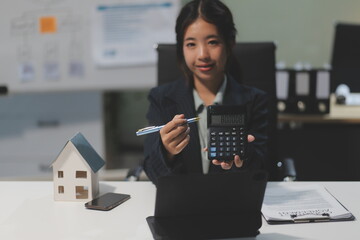 Real estate agents explain models of housing estates in projects to elaborate to clients,...