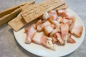 Cuisine Concepts. Traditional Sliced Ukrainian Salo Served With Dried Slices of Bread Top view Against Rustic Wooden Table Background
