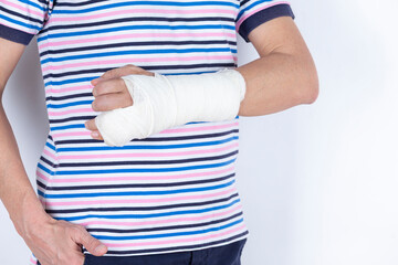 Medical Concepts. Closeup of Caucasian Man Damaged Broken Hand In Plaster and Bandaid Isolated on White Background.