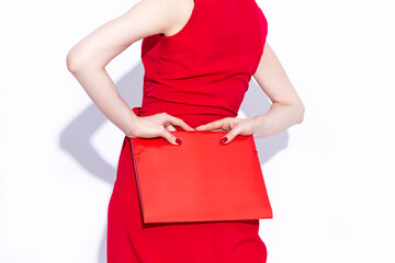 Closeup of Hands of Caucasian Business Woman in Long Red Dress Posing With Red Folder Over White