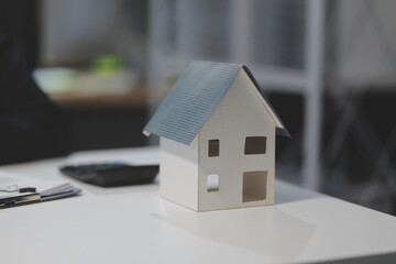Real estate agents explain models of housing estates in projects to elaborate to clients,...