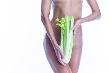 Weight Loss and Healthy Lifestyle Concepts. Nude Caucasian Female With Celery In Front of Bikini Standing With Perfect Slim Shaped  Body Over Pure White Background.