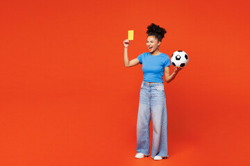 Full body young woman fan in blue t-shirt cheer up support football sport team hold soccer ball...