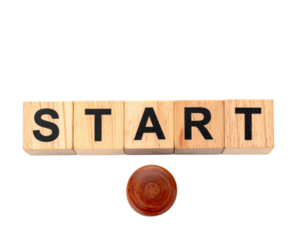 Wooden blocks spell out "START" with a round wooden token beneath them.