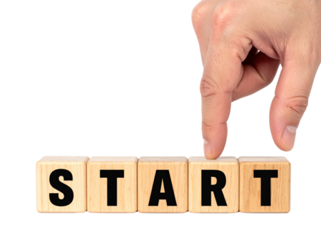 A hand is poised to move wooden blocks that spell out the word "START".