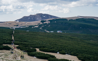 Bucegi Mountains plateau in Romania, showing a vast alpine landscape with scattered patches of snow...