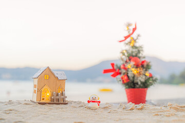 Santa Claus Doll Cute and Christmas Tree House Relaxing on the Beach. Merry Christmas Holiday. Bright Background. Patong Beach, Phuket, Thailand.