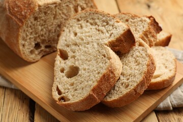 Pieces of fresh bread on wooden table, closeup