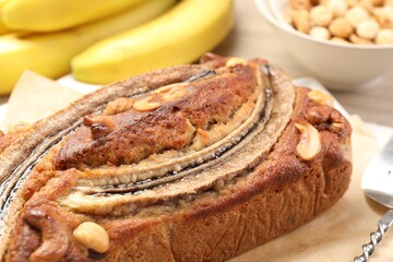 Delicious homemade banana bread with nuts and fruits on table, closeup