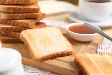 Slices of tasty toasted bread and jam on table, closeup