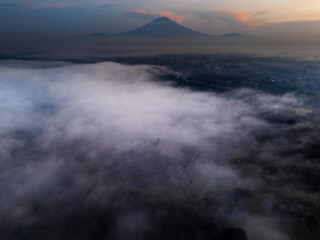 Misty Borobudur temple in the morning with the Merapi, Merbabu and Arjuno mountain in the surroundings. Borodubur is the biggest Buddhist temple in the world that was one of 7 wonders of the worlds.