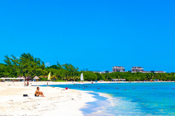 Tropical Caribbean beach people parasols fun Playa del Carmen Mexico. © Arkadi