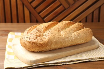 One fresh bread loaf on wooden table