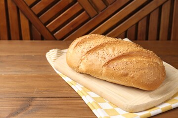 One bread loaf on wooden table Space for text